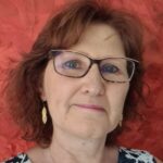 Close-up portrait of woman with glasses and red background
