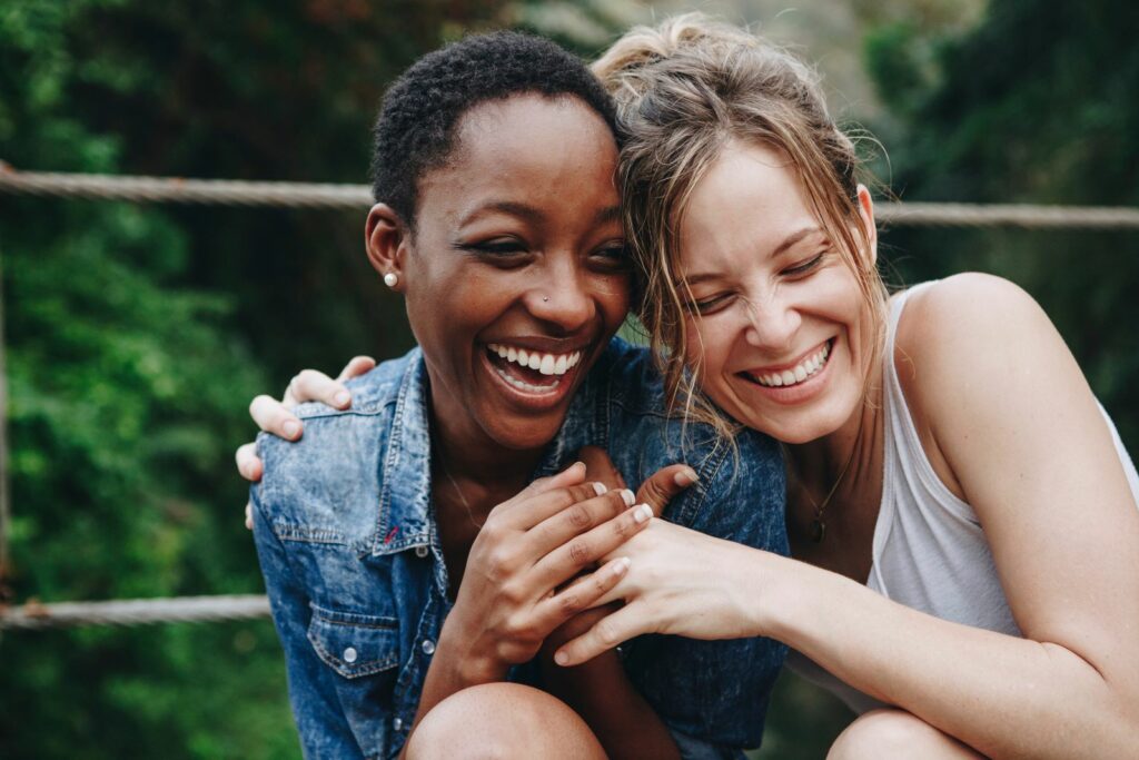 Two friends laughing together outdoors